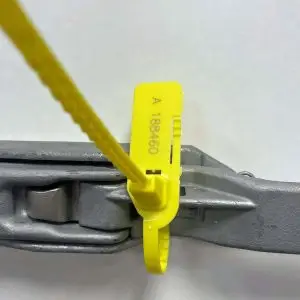 Combilock tamper evident security seal applied to a roll cage – pull-tight plastic seal with tear-off tag for logistics and asset protection